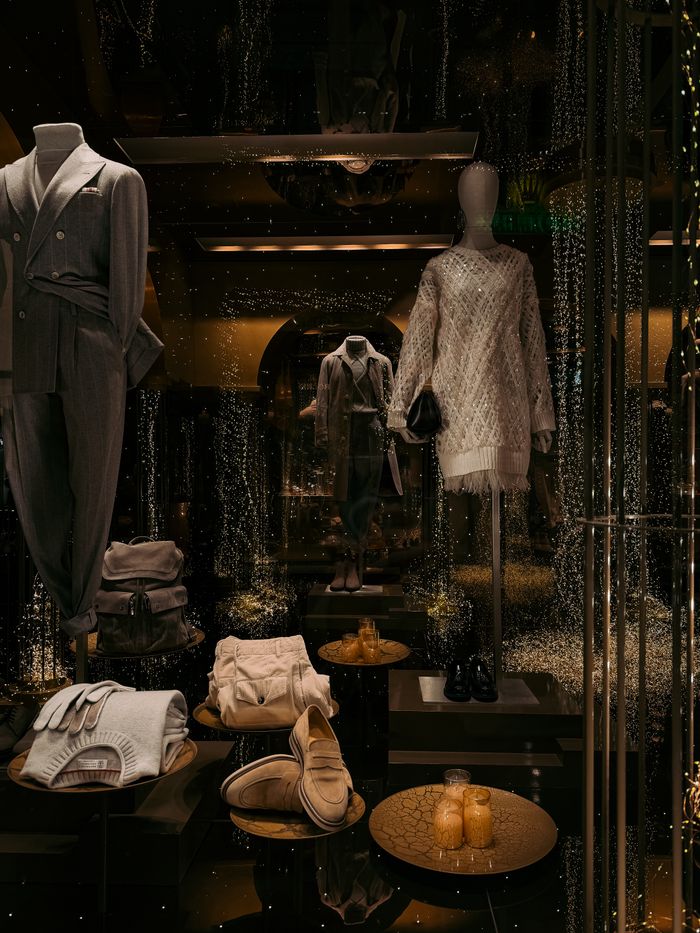 Mastering the First Impression: Your intriguing post title goes here Luxurious fashion window display in Milan showcasing stylish outfits and accessories with a festive atmosphere.
