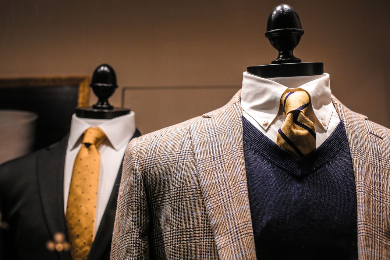 Crafting Captivating Headlines: Your awesome post title goes here Dandy fancy jackets with shiny ties on dummies in showroom of contemporary male shop