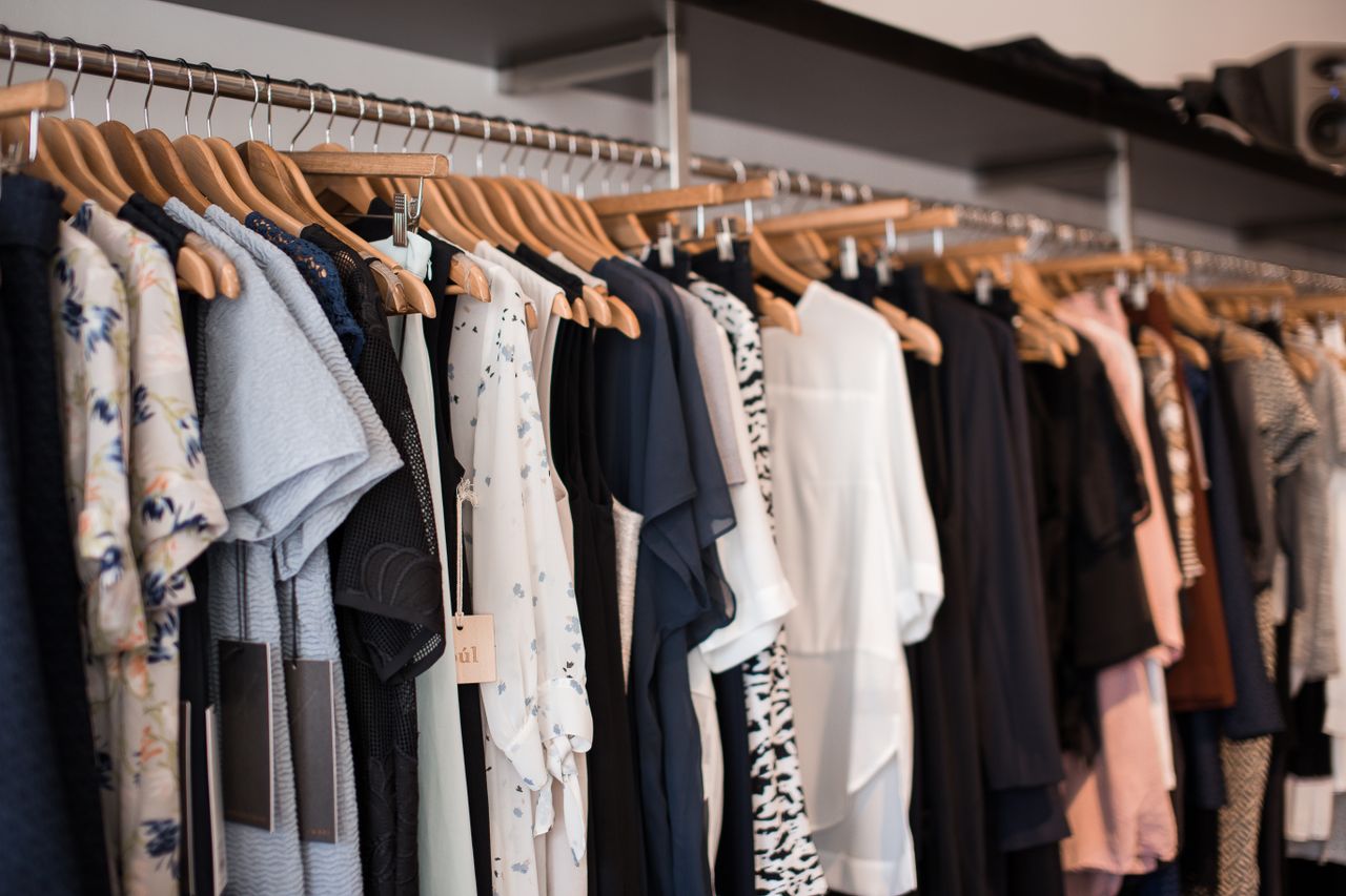 The Art of Drawing Readers In: Your attractive post title goes here Vibrant clothing display on wooden hangers in a modern boutique setting.